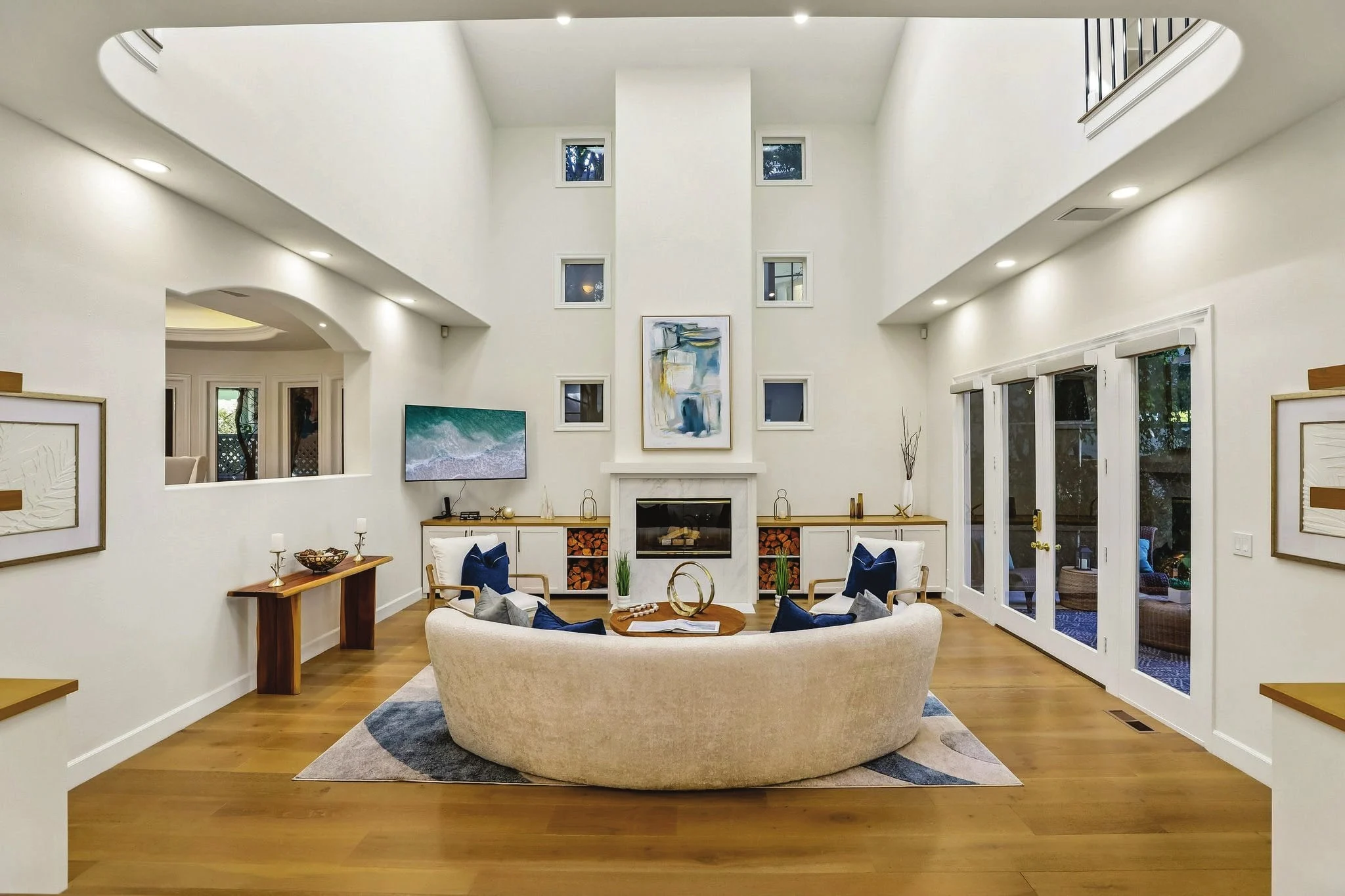 Living room with a double-height ceiling and fireplace at 2300 John Street in Manhattan Beach