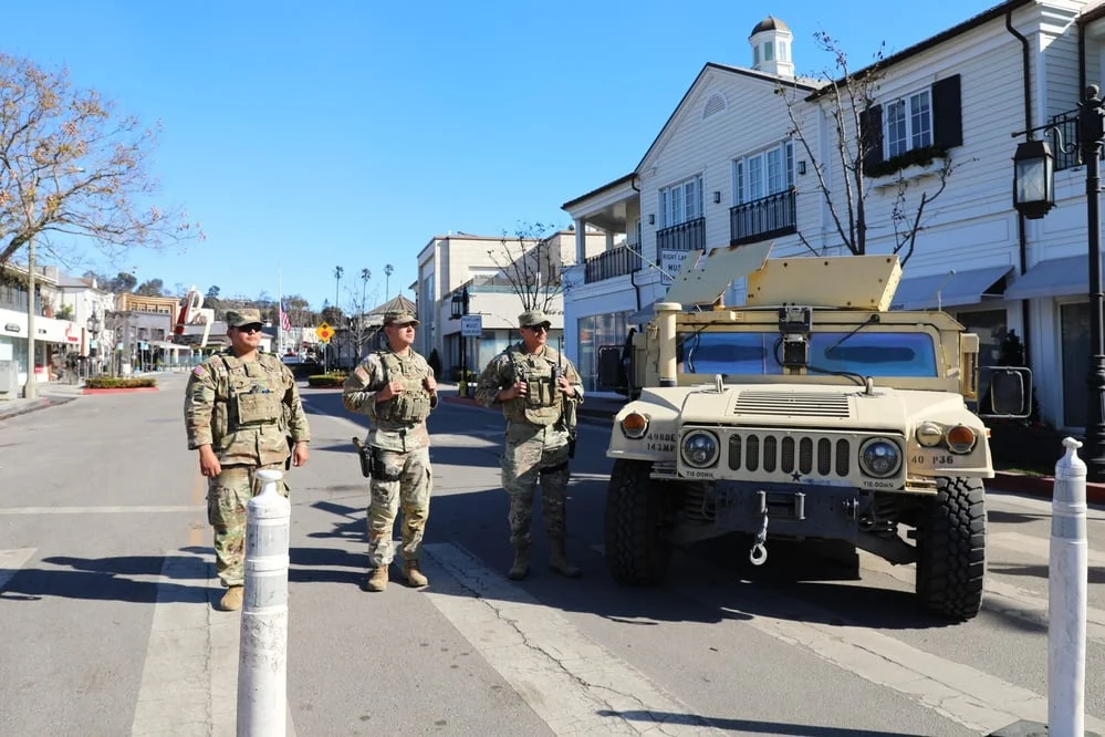 National Guard members and a military vehicle on a street in Pacific Palisades after the January 2025 fire